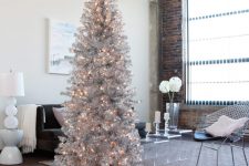 a tall shiny silver Christmas tree will perfecly fit a modern space, just add some lights for a sparkling look