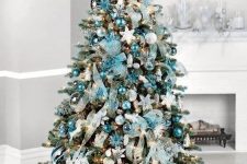 a tiffany blue Christmas tree with various ornaments, ribbons, lights and a silve star topper is a bold and chic idea
