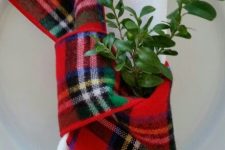 a white napkin with a bright plaid ribbon and some greenery will make your Christmas tablescape very chic and holiday-like