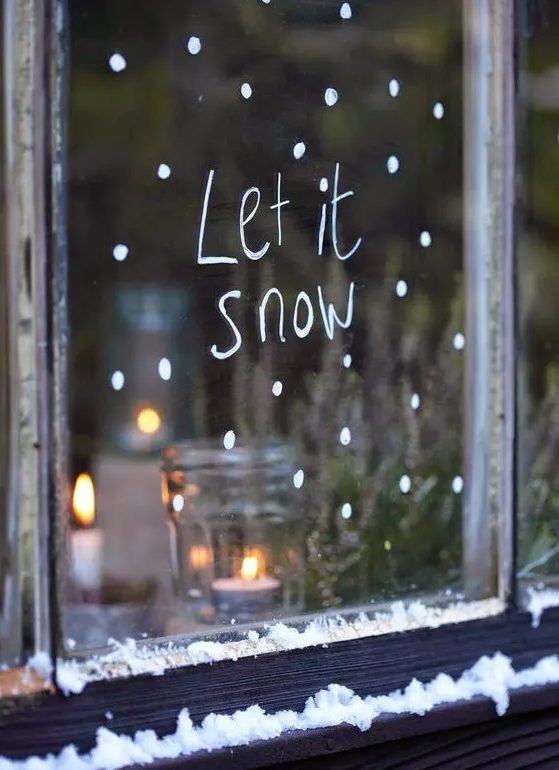 a window decorated with white paint and words from a famous song, this is an easy craft, just use the paint that you can remove