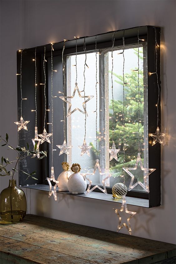 a window styled with star lights and dolls looks very beautiful, modern and Christmassy, it's very cool