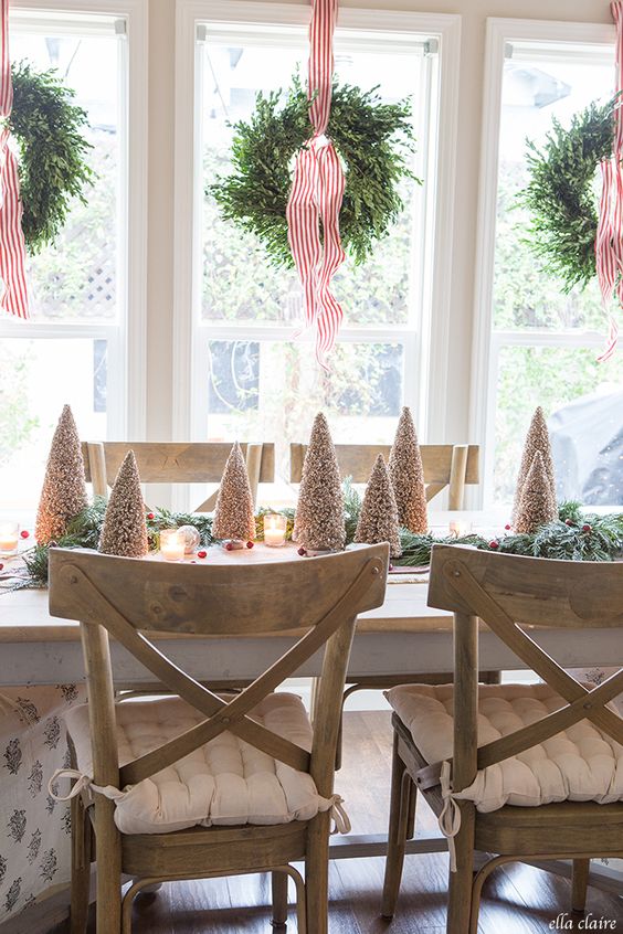 boxwood wreaths on striped red ribbons add catchiness and style to the space and make it look very wintry-like