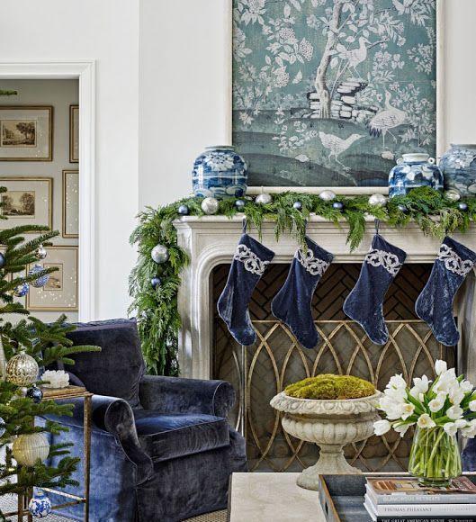 chic Christmas decor with navy and white stockings chinoiserie vases, a garland with silver and blue ornaments