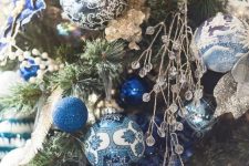 chic painted blue, silver and gold ornaments with glitter and crystals and gold ribbons for a fantastic Christmas tree