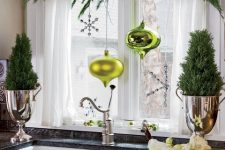 evergreens with neon green ornaments and a snowflake plus mini trees on both sides for bright Christmas decor