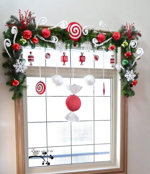 faux candies in red-white tones would become a great addition to an evergreen swag topping the window
