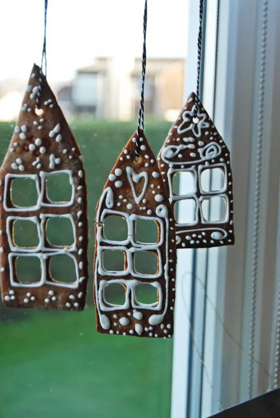 gingerbread house cookies hanging on the window will be a super creative and cool way to style a space for th eholidays