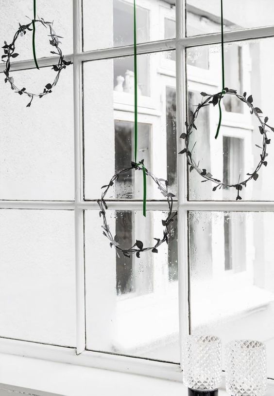 minimal leaf Christmas wreaths hanging on the window will give your space a holiday feel at once