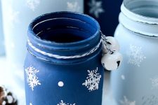 pastel and deep blue jars with painted snowflakes and bells can be used as vases for Christmas arrangements