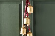 pinecones and vintage bells cna be hung on your front door instead of a usual Christmas wreath and they will bring a rustic holiday feel