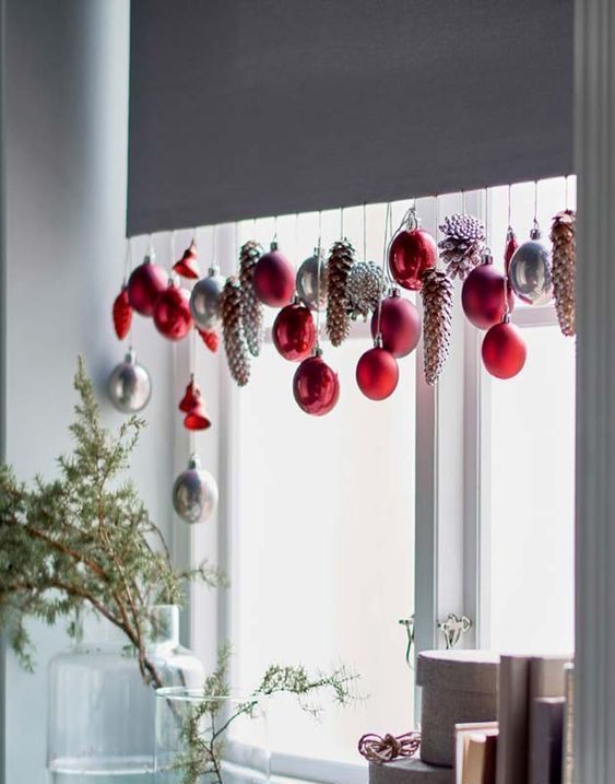 red, silver ornaments and dyed pinecones hanging on the shades will add a cool feel to the space and make it Christmassy