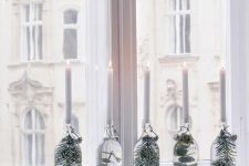 sheer bottles with foliage and greenery and white candles on top are amazing for table or windowsill decor are great