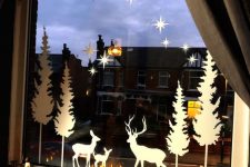 silhouettes attached to the window is a vintage and elegant way to decorate a window for Christmas and add a cozy feel to the space