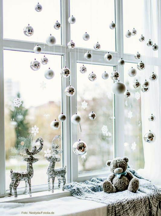 silver and white ornaments, snowflakes and deer will isntantly make your window look like Christmas