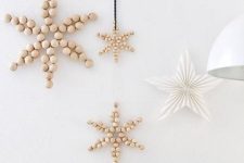 simple and lovely Nordic Christmas decor with wooden bead stars and a paper folded one will bring peacefulness and coziness