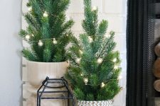 small Christmas trees with lights, in wooden and woven baskets, a lantern with wooden beads is a lovely Nordic decor idea