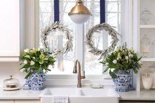 small silver leaf wreaths hanging on blue ribbon are cool and catchy decoration for the space