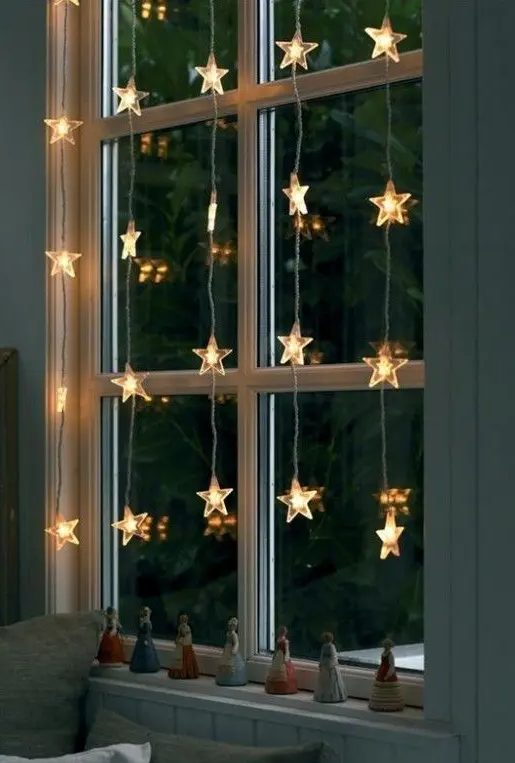 star-shaped lights are a timeless and most loved solution to style a window for Christmas, they look super cool