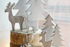 tree stumps with snowflakes attached with rope, with white trees and deer are lovely for creating a cozy winter scene