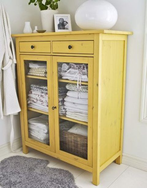 a vintage mustard glass cabinet will be a cool solution to add color and a refined farmhouse touch to your bathroom or bedroom