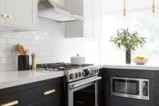 a black and grey L-shaped kitchen with a printed tile floor, a white subway tile backsplash and white stone countertops