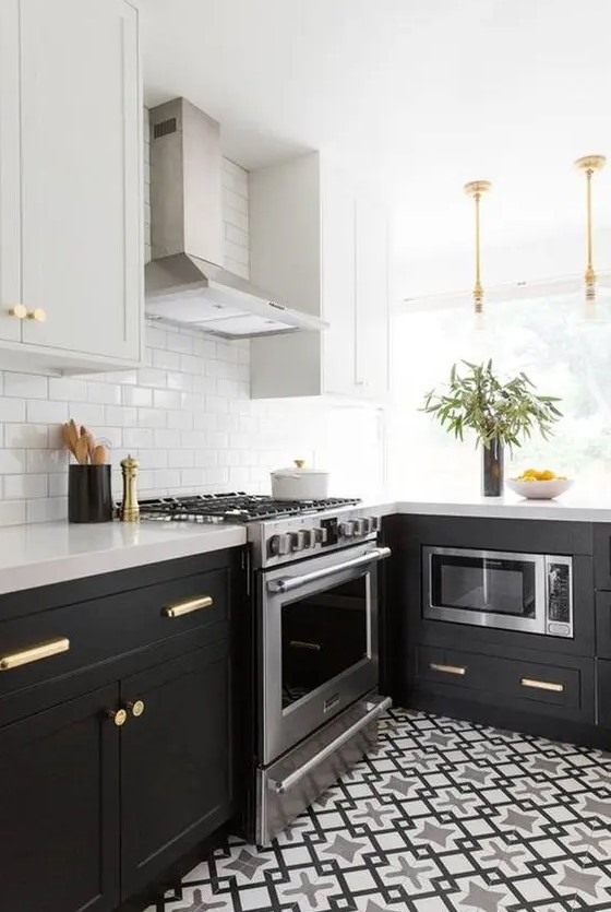 A black and grey L shaped kitchen with a printed tile floor, a white subway tile backsplash and white stone countertops