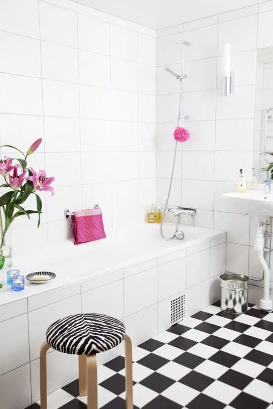 a black and white Nordic bathroom spruced up with bright pink touches and prints
