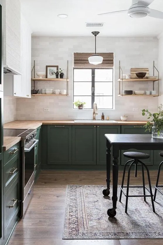 A bold green and white L shaped kitchen with butcherblock countertops, open shelves and brass touches is very cozy