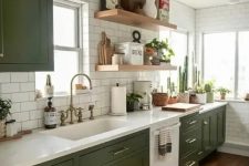 a chic modern meets boho kitchen with olive green shaker cabients, white stone countertops, white subway tiles and open shelves