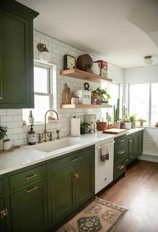 An elegant kitchen that combines modern and boho elements, highlighted by olive green shaker cabinets. The white stone countertops and white subway tiles enhance the open shelves' appeal. A perfect blend of style and functionality.