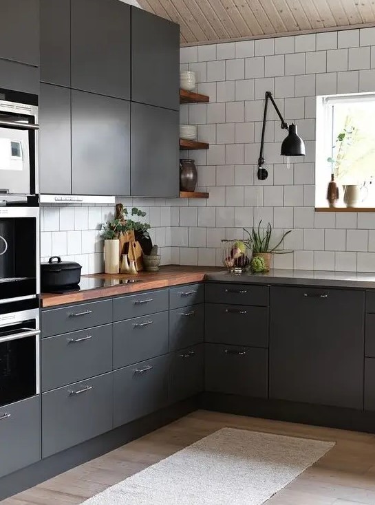 A contemporary graphite grey kitchen with white tiles and rich colored wooden countertops to refresh