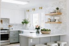 a grey farmhouse U-shaped kitchen with white stone countertops, open shelves, gold sconces, white stools