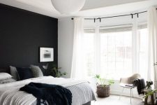 a stylish bedroom with a bay window