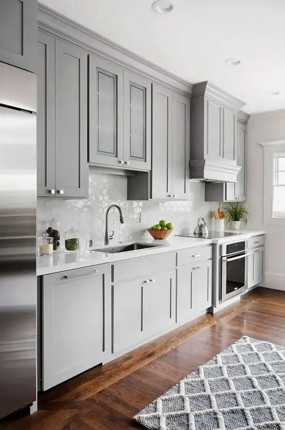 A light grey kitchen with a cool hex tile backsplash and stainless steel appliances is a chic and pretty idea.