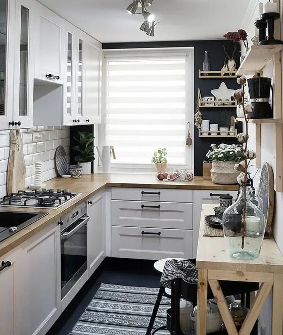 A lovely Scandinavian kitchen in black and white, with light stained wood and enough light is cool