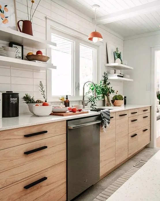 A mid-century modern blonde wood kitchen with open shelves, black handles and a skinny tile backsplash.