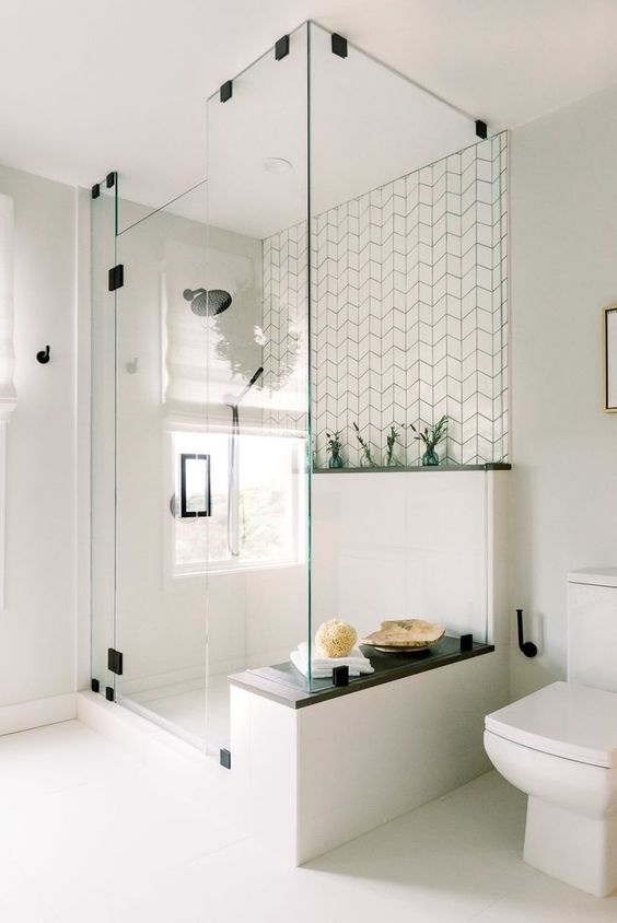 a modern Scandinavian bathroom with all neutral everything, cool tiles for an accent and some touches of black