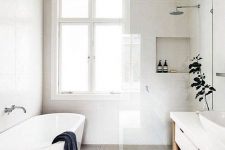 a neutral Scandinavian bathroom with a shower and a tub, a vanity, a sink, greenery and a window