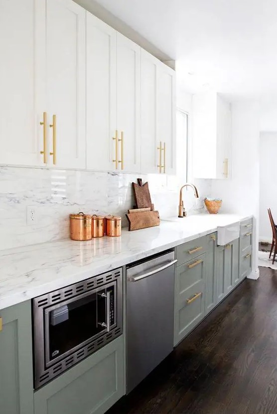 a pretty two-tone one wall kitchen in white and olive green, with white stone countertops and a backsplash plus gold handles