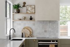 a sophisticated two-tone L-shaped kitchen with sleek cabients, open shelves, a Zellige tile backsplash and white stone countertops