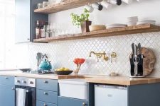 a stylish blue one wall kitchen with a white Moroccan tile backsplash and butcherblock coutnertops is very chic