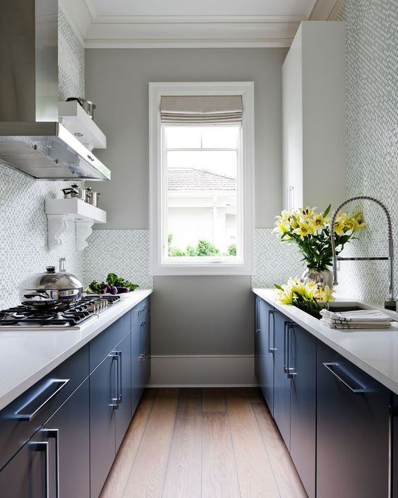 a stylish kitchen with navy cabinets, white stone countertops, a neutral tile backsplash is a cool idea if you don't have much space