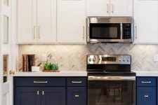 a stylish navy and white one wall kitchen with a grey tile backsplash and a white stone countertop plus built-in lights