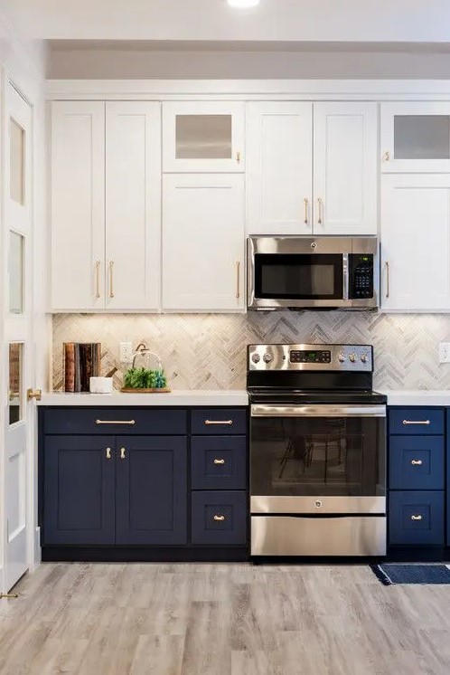 A stylish navy and white one wall kitchen with a grey tile backsplash and a white stone countertop plus built-in lights.