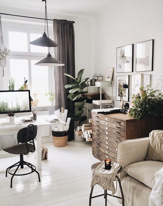 a Scandinavian home office in neutrals, with vintage furniture, metal pendant lamps and potted greenery and succulents