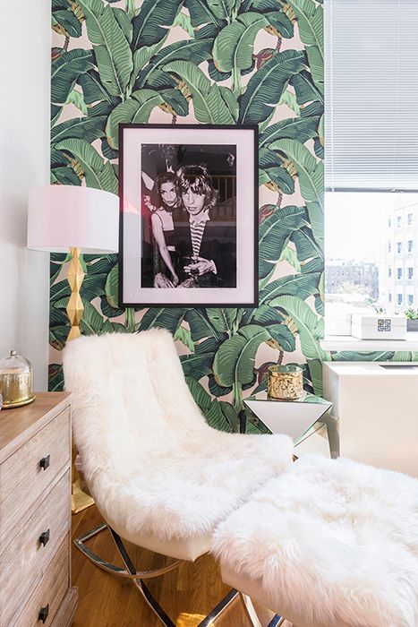 a glam nook with banana leaf wallpaper, a faux fur lounger, a glam lamp and candleholders is very cool