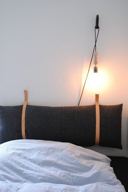 a long and large pillow headboard suspended on wooden straps is a cozy and warming up idea