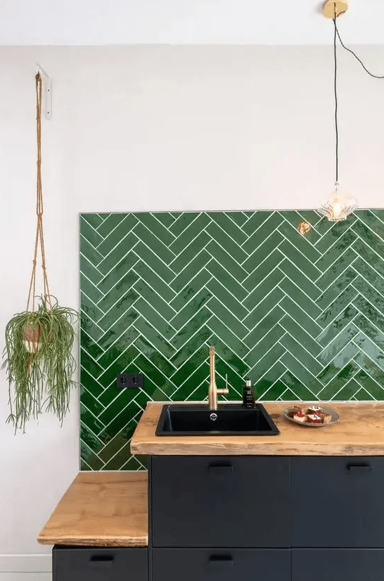 a graphite grey kitchen, butcherblock countertops and a bold green chevron tile backsplash for a lovely and bright look