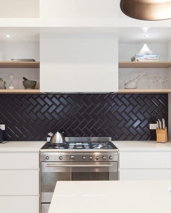 a refined minimalist white kitchen with a black herringbone backsplash and open shelves is very stylish