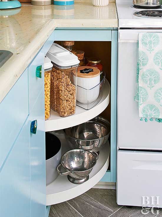 a blue lazy susan corner cabinet has no doors to make access to the inside faster and easier
